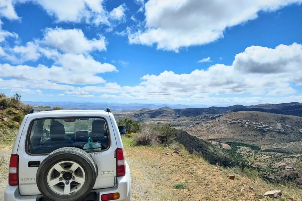 A self-drive car overlooking the vast mountain landscape in Mountain Zebra National Park, South Africa